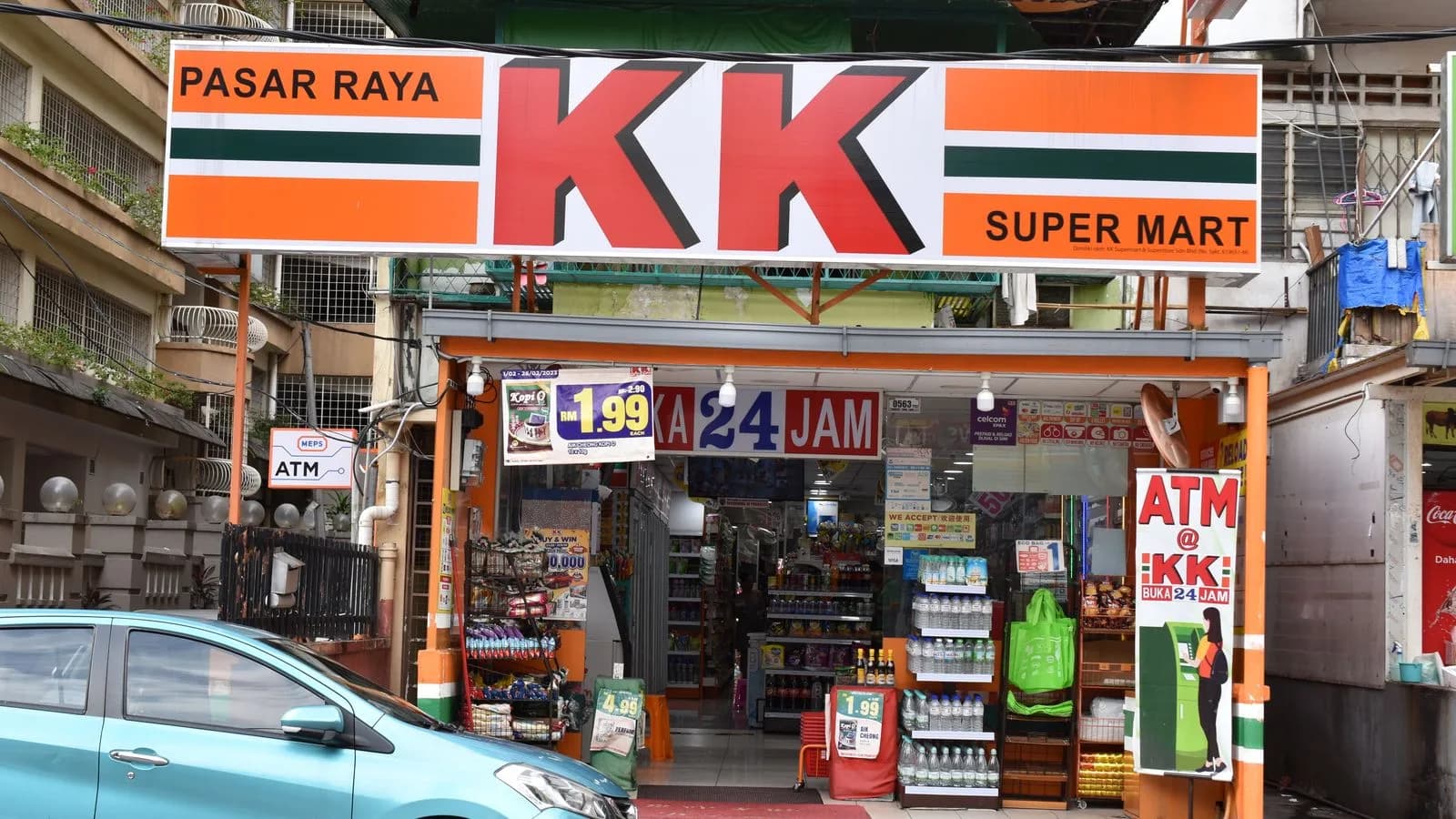 The orange, green and white storefront of KK Super Mart in Kuala Lumpur.