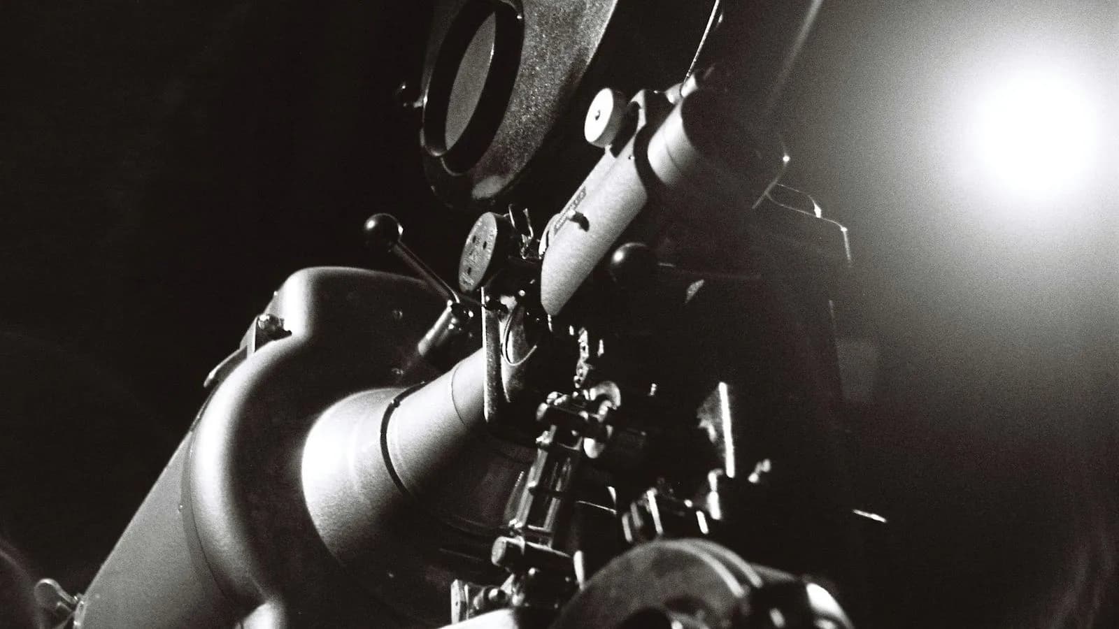 A cinema camera and lens beside a bright film light. Illustrative photo.